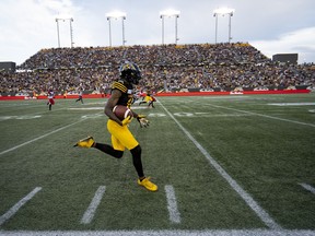 Hamilton Tiger Cats wide receiver Brandon Banks (16) runs back a kick-off return for a touchdown during first half CFL football game action against the Calgary Stampeders, in Hamilton, Ont., on Saturday. Photo by Peter Power/The Canadian Press.