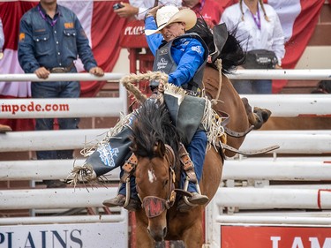 Rusty Wright of Milford, Ut., won Saddle Bronc on Get Smart at the Calgary Stampede in Calgary, Ab., on Sunday July 14, 2019. Mike Drew/Postmedia