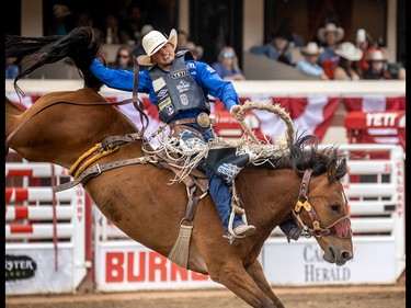 Rusty Wright of Milford, Ut., won Saddle Bronc on Get Smart at the Calgary Stampede in Calgary, Ab., on Sunday July 14, 2019. Mike Drew/Postmedia
