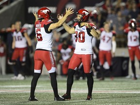 Calgary Stampeders kicker Rene Paredes, right, celebrates his game winning kick with teammate Rob Maver as they took on the the Ottawa Redblacks during second half CFL action in Ottawa on Thursday. The Stamps took the Redblacks 17-16. Photo by Sean Kilpatrick/The Canadian Press.