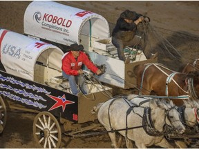 Mark Sutherland, left, challenges Cody Ridsdale for second place in Heat 7 of the Rangeland Derby chuckwagon races at the Calgary Stampede in Calgary, Ab., on Friday July 5, 2019. Mike Drew/Postmedia