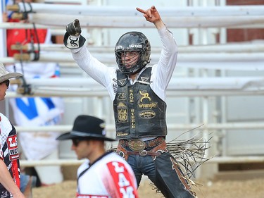 Bull Riding Champion Sage Steele Kimzey, of Strong City, Okla., celebrates after scoring a 92.5 on a bull named Night Moves in the bull-riding event during Championship Sunday at the 2019 Calgary Stampede rodeo on Sunday, July 14, 2019. Al Charest / Postmedia
