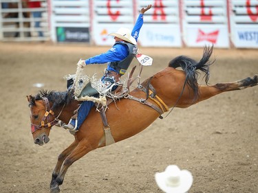 Saddle Bronc Champion Rusty Wright of Milford, Utah, rides Get Smart to a score of 92 in the the saddle-bronc event during Championship Sunday at the 2019 Calgary Stampede rodeo on Sunday, July 14, 2019. Al Charest / Postmedia