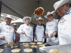 Alberta Premier Jason Kenney, second left, hosts a Stampede breakfast with visiting premiers, left to right, Doug Ford, of Ontario, Blaine Higgs, of New Brunswick, Scott Moe, of Saskatchewan, and Robert McLeod, of the Northwest Territories,in Calgary, Monday, July 8, 2019.THE CANADIAN PRESS/Jeff McIntosh
