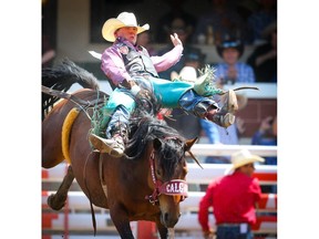 Jacob Stemo of Bashaw, Alberta, rides Arbitrator Joe to a score of 88 in Day 3 of the Calgary Stampede rodeo bareback event on  Sunday, July 7, 2019. Al Charest / Postmedia