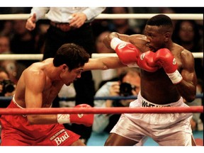 FILE PHOTO: Oscar De La Hoya (L) lands a punch to the body of Pernell Whitaker during their WBC Welterweight Championship fight in Las Vegas, April 12 1997. De La Hoya won the 12 round bout by unanimous decision to claim the championship. R. Marsh Starks/Reuters/File Photo ORG XMIT: FW1