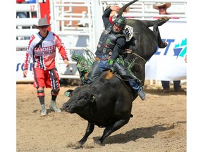 Brazilian cowboy Jose Vitor Leme hangs on tight for an 91 on a bull named Rebel Soul during the bull-riding event at the Calgary Stampede rodeo on Thursday, July 11, 2019. Al Charest / Postmedia