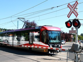 A Calgary Transit LRT crosses the intersection near Sunnyside station in NW Calgary Monday, July 29, 2019. Dean Pilling/Postmedia