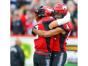Calgary Stampeders Juwan Brescacin celebrates with quarterback Nick Arbuckle after his touchdown against the Toronto Argonauts during CFL football in Calgary on Thursday, July 18, 2019. Al Charest/Postmedia