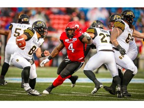 Hamilton Tiger-Cats Jeremiah Masoli looks to throw under pressure from Micah Johnson of the Calgary Stampeders during CFL football in Calgary on Saturday, June 16, 2018. Al Charest/Postmedia