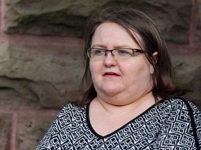 Elizabeth Wettlaufer is escorted by police from the courthouse in Woodstock, Ont., on June 26, 2017.