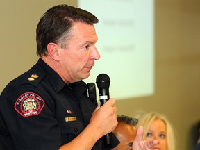 Cliff O'Brien with the Calgary Police Service speaks to members of the community during a Town Hall Meeting on Public Safety & Community Violence at the Genesis Centre to address concerns around public safety and crime and violence reduction around the northeast. Tuesday, July 23, 2019. Brendan Miller/Postmedia
