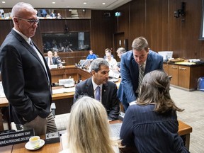 Conservative MPs Glen Motz, left, Pierre Paul-Hus, left, and Alupa Clarke speak to staff before the Standing Committee on Public Safety and National Security to discuss their request for a study of the Desjardins Group Data Breach, in Ottawa on Monday, July 15, 2019.