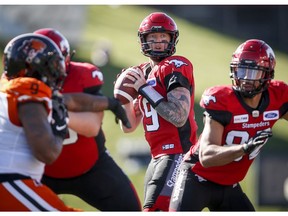 CP-Web.  Calgary Stampeders quarterback Bo Levi Mitchell, centre, looks for a receiver during first half CFL football action against the B.C. Lions, in Calgary, Saturday, June 29, 2019.