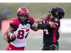 Calgary Stampeders wide receiver Juwan Brescacin fouls Ottawa Redblacks defensive back Anthony Cioffi during CFL action in Ottawa on Thursday.