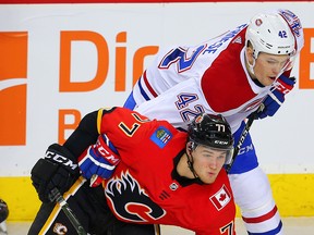 Byron Froese checks Flames Mark Jankowski while a member of the Montreal Canadiens in 2017. Froese has signed a one-year, two-way contract with the Flames.