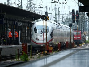 Officials walk on a platform at the main train station in Frankfurt, Germany, July 29, 2019, after a 40-year-old man of African origin pushed an eight-year-old boy in front of an oncoming train, killing him, police said.