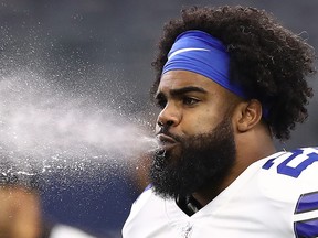 Dallas Cowboys' Ezekiel Elliott spits water before a game against the Detroit Lions at AT&T Stadium on Sept. 30, 2018 in Arlington, Texas. (Ronald Martinez/Getty Images)