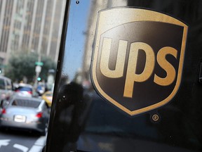 A United Parcel Service logo is displayed on a delivery truck on October 24, 2014 in San Francisco, California. United Parcel Service reported quarterly earnings that beat analyst estimates with revenue of $14.29 billion compared to $13.52 billion one year ago.