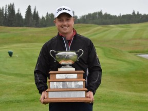 Photo of Andrew Harrison with Alberta Am trophy.