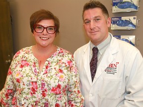 Patient Michelle Kotelko looks over her chart with Dr. Brian Clarke,a  heart specialist at Foothills Medical Centre. Kotelko has a new wireless sensor implanted into the pulmonary artery of her heart. Monday, July 22, 2019. Dean Pilling/Postmedia