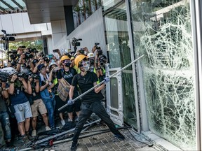 Protesters smash glass doors and windows of the Legislative Council Complex in Hong Kong, China, on July 1, 2019.