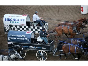 Jason Glass and the Birchcliff Energy wagon is passed by Todd Baptiste and the Manteo and Groundswell wagon at the finish in heat 8 in the GMC Rangeland Derby at the Calgary Stampede on Tuesday evening July 9, 2019. Glass knocked down a barrel in the heat. Gavin Young/Postmedia