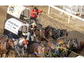 Dallas Dyck holds off Kris Flanagan to take Heat 1 of the Rangeland Derby chuckwagon races at the Calgary Stampede in Calgary, Ab., on Sunday, July 7, 2019. Mike Drew/Postmedia