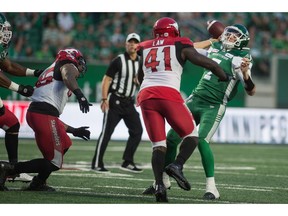 REGINA, SASK : July 6, 2019 -- Saskatchewan Roughriders quarterback Cody Fajardo (7) attempts a pass with the ball while under pressure from the Calgary Stampeders Cordarro Law (41) during a game at Mosaic Stadium. BRANDON HARDER/ Regina Leader-Post ORG XMIT: POS1907062339365750