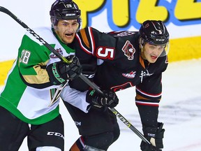 Flames prospect Jackson van de Leest, right, during a Calgary Hitmen game on Oct. 8, 2018.