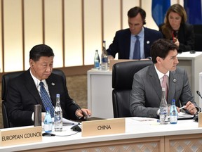 Xi Jinping, China's president, left, and Justin Trudeau, Canada's prime minister, attend a session at the Group of 20 (G-20) summit in Osaka, Japan, on Saturday, June 29, 2019.