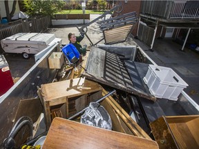 Liam Hamilton, of JUSTJUNK, helps to clear out various thing no longer needed from a home in Toronto, Ont. on Wednesday October 25, 2017. Ernest Doroszuk/Toronto Sun/Postmedia Network
