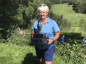 Calgary’s Kim Carrington collects the hardware after winning the 2019 Alberta Senior Ladies’ Championship at Pine Hills in Rocky Mountain House.