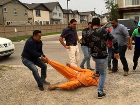 Journalist Kumar Sharma is swarmed by a group of men during an outdoor Punjabi concert on Aug. 19, 2018.