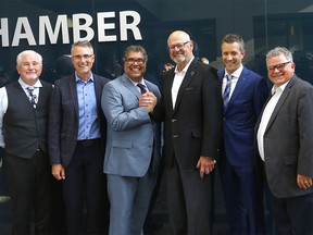 Calgary Mayor Naheed Nenshi and Ken King shake hands with L-R, councillors, Ward Sutherland, John Bean. President & CEO, Jeff Davison and Shane Keating as council voted for a new arena in Calgary on Tuesday, July 30, 2019. Darren Makowichuk/Postmedia