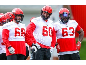 Calgary Stampeders offensive linemen Justin Lawrence, Shane Bergman and Derek Dennis during practice on Tuesday, July 16, 2019. The Stampeders will take on the Toronto Argonauts this tomorrow at McMahon Stadium. Al Charest / Postmedia