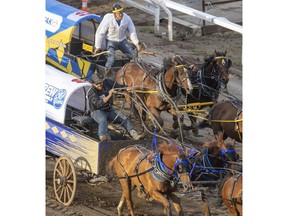 Chance Bensmiller holds off Jamie Laboucane to take Heat 4 of the Rangeland Derby chuckwagon races at the Calgary Stampede in Calgary on Friday. Photo by Mike Drew/Postmedia.