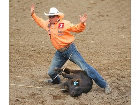 Matt Shiozawa, of Chubbuck, Idaho, tied with Timber Moore for top-spot with a time of 7.0 seconds in the tie-down roping event on Wild Card Saturday at the Calgary Stampede. Both cowboys advance to Showdown Sunday. Photo by Al Charest/Postmedia.