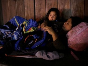 A migrant with her daughter, who returned to Mexico from the United States to await their court hearing for asylum seekers, as part of the legal proceedings under a new policy established by the U.S. government, rest outside the Our Lady of Guadalupe Cathedral in Ciudad Juarez, Mexico, July 14, 2019. Picture taken July 14, 2019.