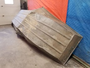 This image released on August 4, 2019 by the Royal Canadian Mounted Police (RCMP) shows a damaged aluminium boat they found on the shore of the Nelson river as they are searching for Kam McLeod and Bryer Schmeglsky. - Kam McLeod and Bryer Schmegelsky have been on the run since 23-year-old Australian Lucas Fowler and his American girlfriend Chynna Deese, 24, were found shot dead alongside the Alaska Highway in northern British Columbia.