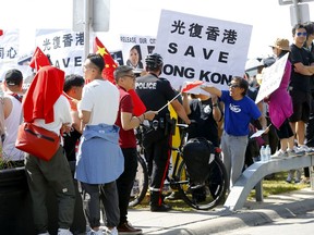The Canada Save Hong Kong team held a rally on Crescent Rd. were Chinese supporters showed up and held an anti-rally as police were called in to keep it civil in Calgary on Saturday, August 17, 2019. Darren Makowichuk/Postmedia