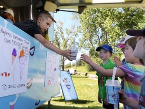 Haylen Astalos sells McFlurries for donations in support of Ronald McDonald House in CalgaryÕs Sandy Beach Park on Sunday August 18, 2019. Haylen, 9, has raised over $30,000 for the charity with his own driveway ice cream stand since his 5th birthday and McDonaldÕs surprised Haylen with a visit from the McFlurry truck to help with his fundraising efforts. Gavin Young/Postmedia