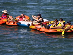 A raft of rafts and their riders enjoy a perfect summer afternoon on the Bow River in Calgary, Sunday August 18, 2019. Gavin Young/Postmedia