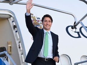 Canadian Prime Minister Justin Trudeau waves as he arrives in Biarritz, south-west France on August 23, 2019, on the eve of the annual G7 Summit.