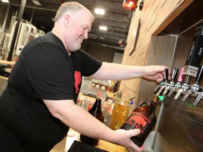 Steve Carlson, Owner of Red Bison Brewery, is seen helping out behind the bar during the micro-breweries last day in business. Saturday, August 24, 2019. Brendan Miller/Postmedia