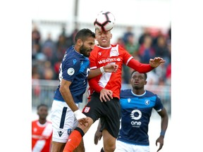 FC Edmonton Ajay Khabra (L) goes up for a ball against Cavalry FC Oliver Minatel during CPL soccer action between Cavalry FC and FC Edmonton at ATCO Field at Spruce Meadows in Calgary on Friday, August 16, 2019. Jim Wells/Postmedia