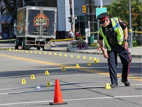 A long line of scene markers trace the route from the point of impact to a large truck after a pedestrian was struck and critically injured at the intersection of 4th Street and 13th Avenue S.W. Tuesday morning August 20, 2019.  Gavin Young/Postmedia