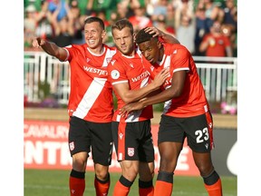 Cavalry FC (L-R) Oliver Minatel, Nico Pasquotti and Dominique Malonga celebrate Malonga's first half goal during CPL soccer action between Cavalry FC and York9 Football Club at ATCO Field at Spruce Meadows in Calgary on Wednesday, August 21, 2019. Jim Wells/Postmedia