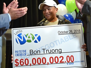 Bon Truong is the winner of the long-awaited $60 million LOTTO MAX jackpot prize from the October 26 draw, here accepting his cheque at the Alberta Gaming, Liquor and Cannabis Office in St. Albert, August 28, 2019. Ed Kaiser/Postmedia