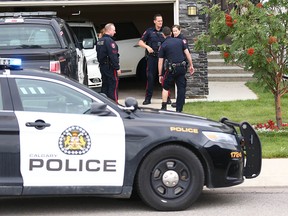 Calgary police investigate  a home on Panatella Blvd. N.W., where an officer was accidentally bitten by a police dog on Friday, Aug. 16, 2019.